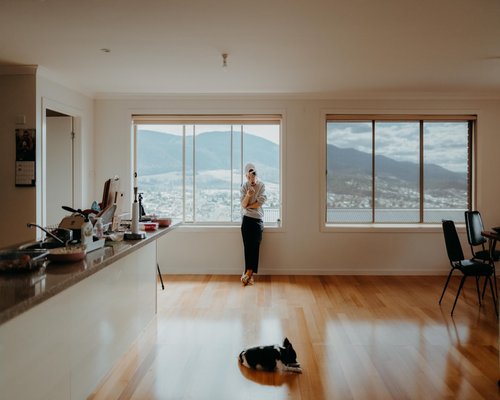 Person working on laptop with good posture in a bright room